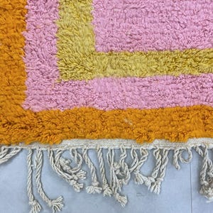 Unique handmade area rug, featuring warm and inviting tones.