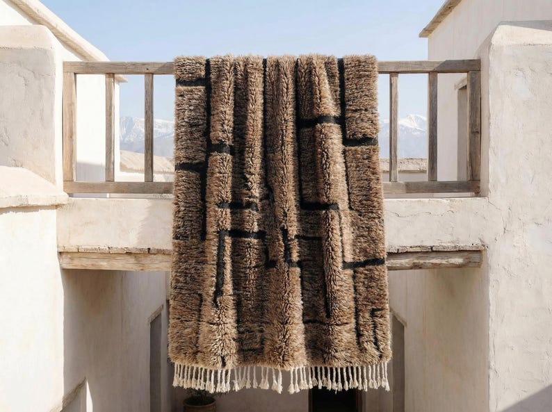 Chocolate brown rug hand tufted in Morocco from 100% natural wool, featuring a plush high pile with subtle black geometric texture. This solid brown wool rug showcases earthy tones and a minimalist Berber-inspired design, finished with soft fringe. Ideal as a warm modern area rug for Scandinavian, boho, or earthy interior spaces