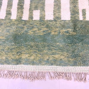 Fringed edge of green Berber rug with tight weave and thick wool – durable Moroccan floor decor