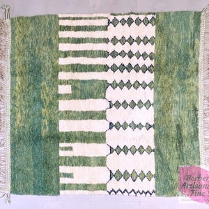 Top-down view of green Moroccan rug with abstract white lines and symmetrical design – wool area rug ideal for modern home decor