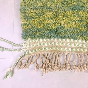 Extreme close-up of plush green wool with raised pattern – thick Moroccan shag rug handcrafted in the Atlas Mountains