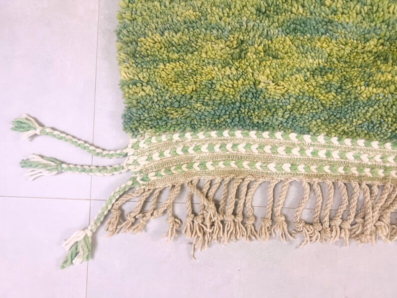 Extreme close-up of plush green wool with raised pattern – thick Moroccan shag rug handcrafted in the Atlas Mountains