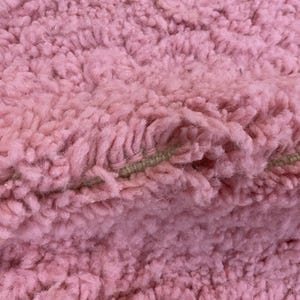 Handwoven wool area rug, crafted by skilled Berber artisans.