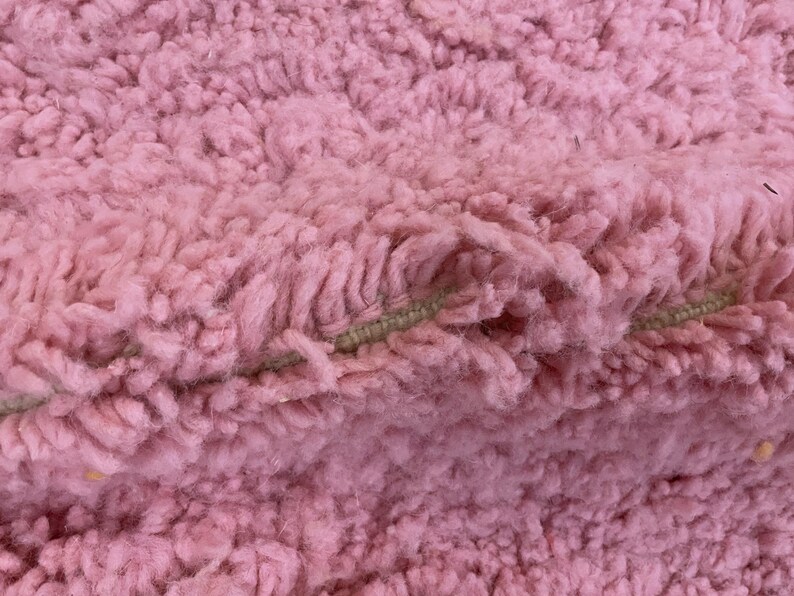 Handwoven wool area rug, crafted by skilled Berber artisans.