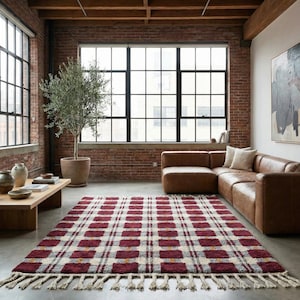 Deep red wool rug with textured checkerboard pattern, handwoven in Morocco using natural wool. This Berber style rug features rich red tones with subtle geometric variation and a plush high pile surface. Ideal as a statement area rug for living room or bedroom, adding warmth, depth, and artisan character to modern or boho interiors.