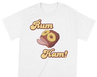 May include: White t-shirt with a retro-style graphic of a ham with pineapple rings and the text "Rum Ham!"