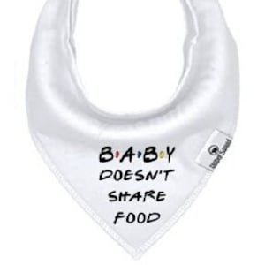 May include: White baby bib with the text "B-A-B-Y DOESN'T SHARE FOOD" in black and colorful letters.