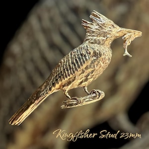 May include: A gold-toned metal kingfisher bird stud earring with a fish in its beak. The stud is 23mm in size. Kingfisher Stud 23mm
