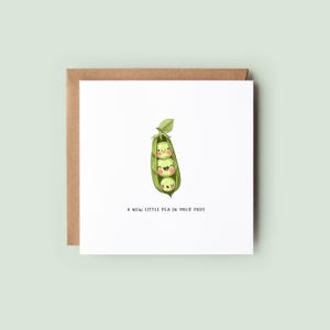 Cute baby congratulations card featuring smiling peas in a pod and the message “A new little pea in your pod,” printed on recycled card with a kraft envelope.