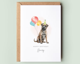 May include: A birthday card featuring a watercolour illustration of a brown and black Border Terrier wearing a green party hat and sitting in front of colourful balloons. The card reads "Happy Birthday Daisy".