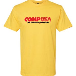 May include: Yellow short-sleeved t-shirt with the red and black logo "CompUSA The Computer Superstore"