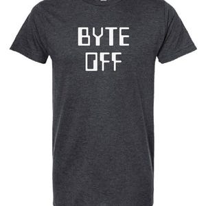 May include: A dark charcoal gray short-sleeve t-shirt featuring the white text "BYTE OFF" printed in a bold, blocky, sans-serif font across the chest. The garment has a crew neckline and a heathered texture throughout the fabric.