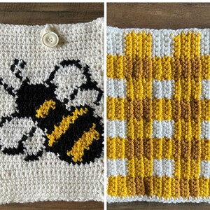 May include: A two-sided crochet square featuring a white background with a black and yellow bee graphic on one side and a yellow, white, and brown checkered pattern on the other. A single white button is attached to the top center of the bee side.