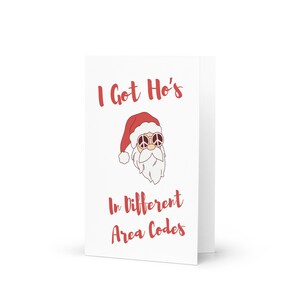 May include: White greeting card with the text "I Got Ho's In Different Area Codes" in red. The card features a cartoon Santa Claus wearing a red hat and peace sign sunglasses.