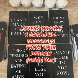 May include: A collection of black oracle cards with white text, featuring phrases like "I can't make you happy" and "These feelings are eating me alive." The cards are labeled "Lovers Oracle 6 Card Pull" and "Messages From Your Person (Same Day)." White rose-shaped candles are at the top.