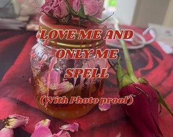 May include: A glass jar with a gold lid filled with rose petals and liquid. The jar has the text "LOVE ME AND ONLY ME SPELL (With Photo proof)" on it. There are dried roses and rose petals on the table.