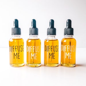 May include: Four amber glass bottles with black dropper tops and white labels that read "Diffuse Me".