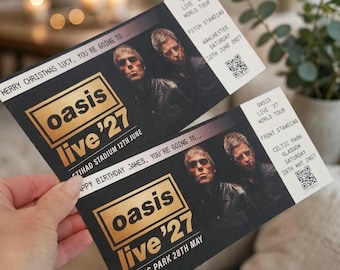 May include: Two rectangular Oasis Live '27 concert tickets with black backgrounds and gold text. One ticket reads Merry Christmas Lucy, you're going to... Etihad Stadium 12th June. The other reads Happy Birthday James, you're going to... Celtic Park 28th May.