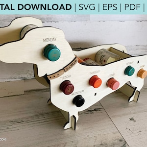 May include: Wooden dachshund wine rack with seven slots for wine bottles. Each slot is labeled with a day of the week, from Monday to Sunday. The rack is painted white and has a brown collar with the word "SOONER" on it.