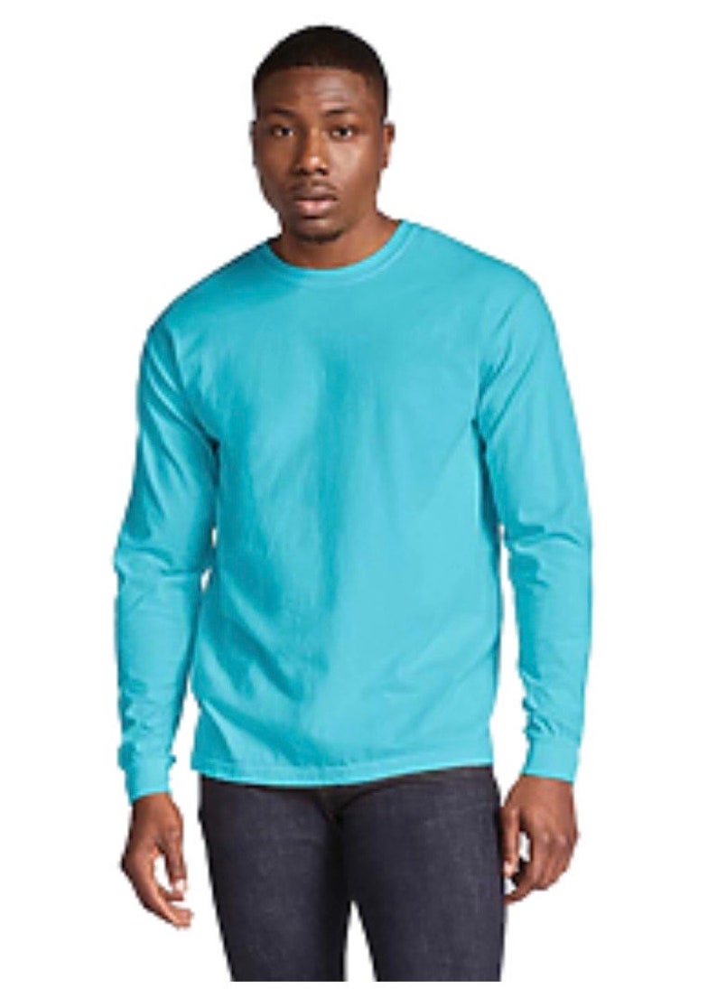 May include: A turquoise long-sleeve t-shirt with a crew neck.