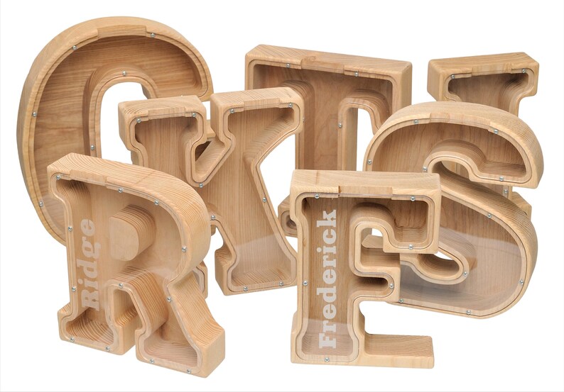 May include: Wooden alphabet letter piggy banks with clear plastic windows. The letters are R, I, D, G, E, F, R, E, D, E, R, I, C, K.