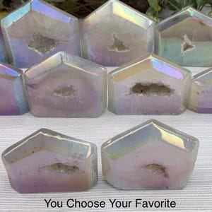 May include: A collection of iridescent agate crystal house shapes. Each house is unique with a natural crystal formation and a rainbow sheen. You Choose Your Favorite.
