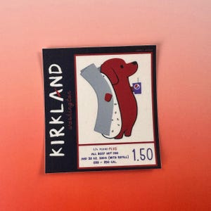 May include: A sticker featuring a cartoon dachshund holding a hot dog and a soda. The sticker has the text "KIRKLAND Washington" and details about the hot dog and soda. The sticker is on a gradient pink and orange background.