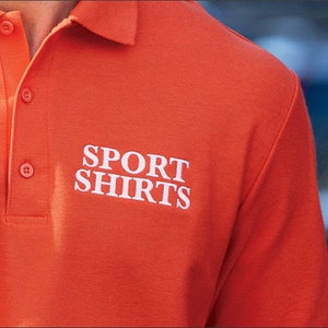 Może przedstawiać: Pomarańczowa koszulka polo z haftowanym białym tekstem "SPORT SHIRTS".
