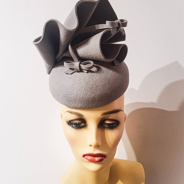 Light grey fascinator with ruffles and bows