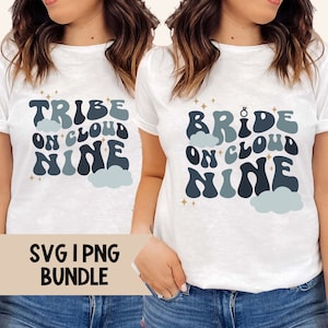 May include: Two white t-shirts with a blue and white graphic design. The text on the shirts reads "Tribe on Cloud Nine" and "Bride on Cloud Nine".