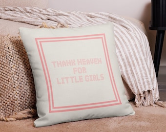 May include: A white throw pillow with a pink double border and the text "THANK HEAVEN FOR LITTLE GIRLS" in pink.