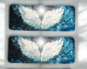 May include: Four rectangular bookmarks featuring a graphic print of large, white, feathered angel wings centered against a dark blue, cloudy background with a bright, glowing light source positioned between the wings.
