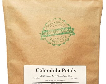 May include: A brown paper bag with a green label that says "Calendula Petals (Calendula L. / Calendulae flos)". The label also includes the text "Best before", "Store in a dry, cool and dark place", "Shender Group LTD", "Unit 45", "Space Business Centre Cheltenham", "Tewkesbury Road", "Cheltenham", "GL51 9FL", "Gloucestershire", "United Kingdom", and "Net weight".