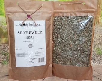 May include: A brown paper bag with a clear window showing dried silverweed herb inside. The bag has a label that says "Health Embassy" and "Silverweed Herb (Potentilla anserina L.)".