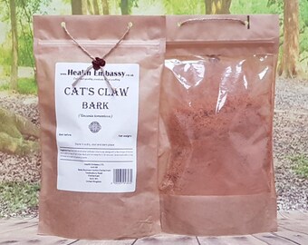 May include: A brown paper bag with a clear plastic window, containing a reddish-brown powder. The bag is labelled "Cat's Claw Bark (Uncaria tomentosa)" and has a website address and other information printed on it.
