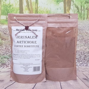 May include: A brown paper bag with a clear window showing a brown powder inside. The bag is labelled "Jerusalem Artichoke Coffee Substitute" and lists the ingredients: 90% roasted Jerusalem Artichoke rhizome, 3% roasted chicory root, 1% cinnamon, cloves, 1% cardamom. The bag also includes instructions for use and storage.