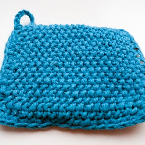 May include: A blue crocheted dishcloth with a loop handle. The dishcloth is made of a textured yarn and has a slightly wavy edge.