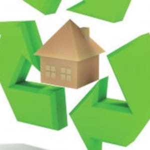 May include: A green recycling symbol with a brown paper house in the centre. The symbol represents eco-friendly and sustainable living.