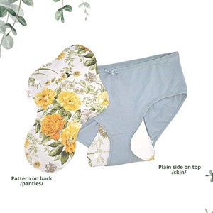 May include: A light blue reusable panty liner with a floral pattern on the back. The liner has a plain side for contact with skin.  The text "Pattern on back /panties/" is written below the liner with a floral pattern. The text "Plain side on top /skin/" is written below the liner with a plain side.