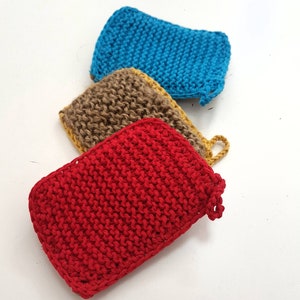 May include: Three knitted dishcloths in red, brown and blue. The dishcloths are made from a textured yarn and have a slightly rough surface.