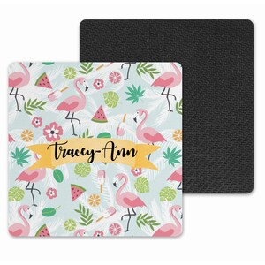 May include: A light blue square coaster featuring a pink flamingo, watermelon, and tropical leaf design. The coaster has a yellow banner with the text "Tracey-Ann" printed on it.