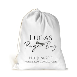 May include: White drawstring bag with the text "Lucas Page Boy" and a black bow tie graphic. The date "14th June 2019" and the text "Auntie Sam & Uncle John" are also printed on the bag.