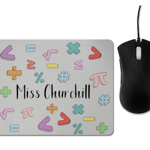 May include: A grey mouse mat with a colourful pattern of maths symbols and the text "Miss Churchill".
