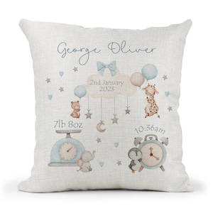 May include: A light blue and white baby announcement cushion with a giraffe, bear, penguin, and elephant. The cushion reads "George Oliver", "2nd January 2023", "7lb 8oz", and "10:36am".