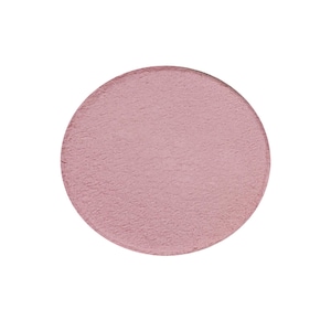 May include: A round, pink blush compact with a smooth, textured surface.