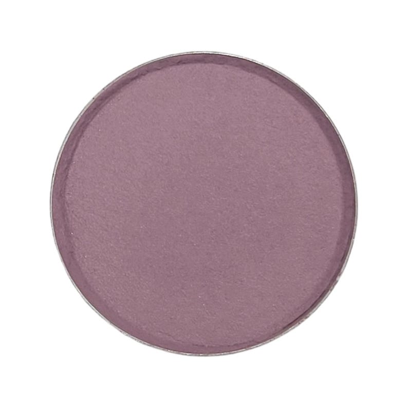 May include: A round, matte eyeshadow pan in a muted mauve color. The eyeshadow is encased in a silver metal compact. The product is isolated on a white background, highlighting the color and texture of the makeup.
