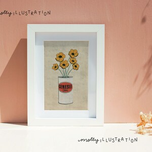 May include: A framed illustration of a can of Genesee beer with yellow flowers in it. The background is a light brown color. The text "molly ILLUSTRATION" is at the top and bottom of the image.