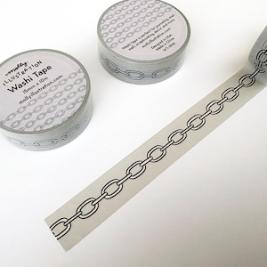 May include: Two rolls of light gray washi tape and one strip of extended tape featuring a repeating black line drawing of a chain link pattern. The circular labels on the rolls display the text molly ILLUSTRATION Washi Tape 15mm x 10m.