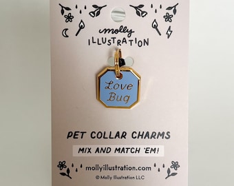 May include: A light pink pet collar charm tag with a gold border and a light blue center. The tag reads "Love Bug" in white text. The tag is attached to a light pink card with the text "PET COLLAR CHARMS" and "MIX AND MATCH 'EM!"