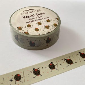 May include: A roll of green washi tape with a repeating pattern of cartoon characters dancing. The tape is labeled "molly illustration washi tape 15mm x 10m mollyillustration.com".